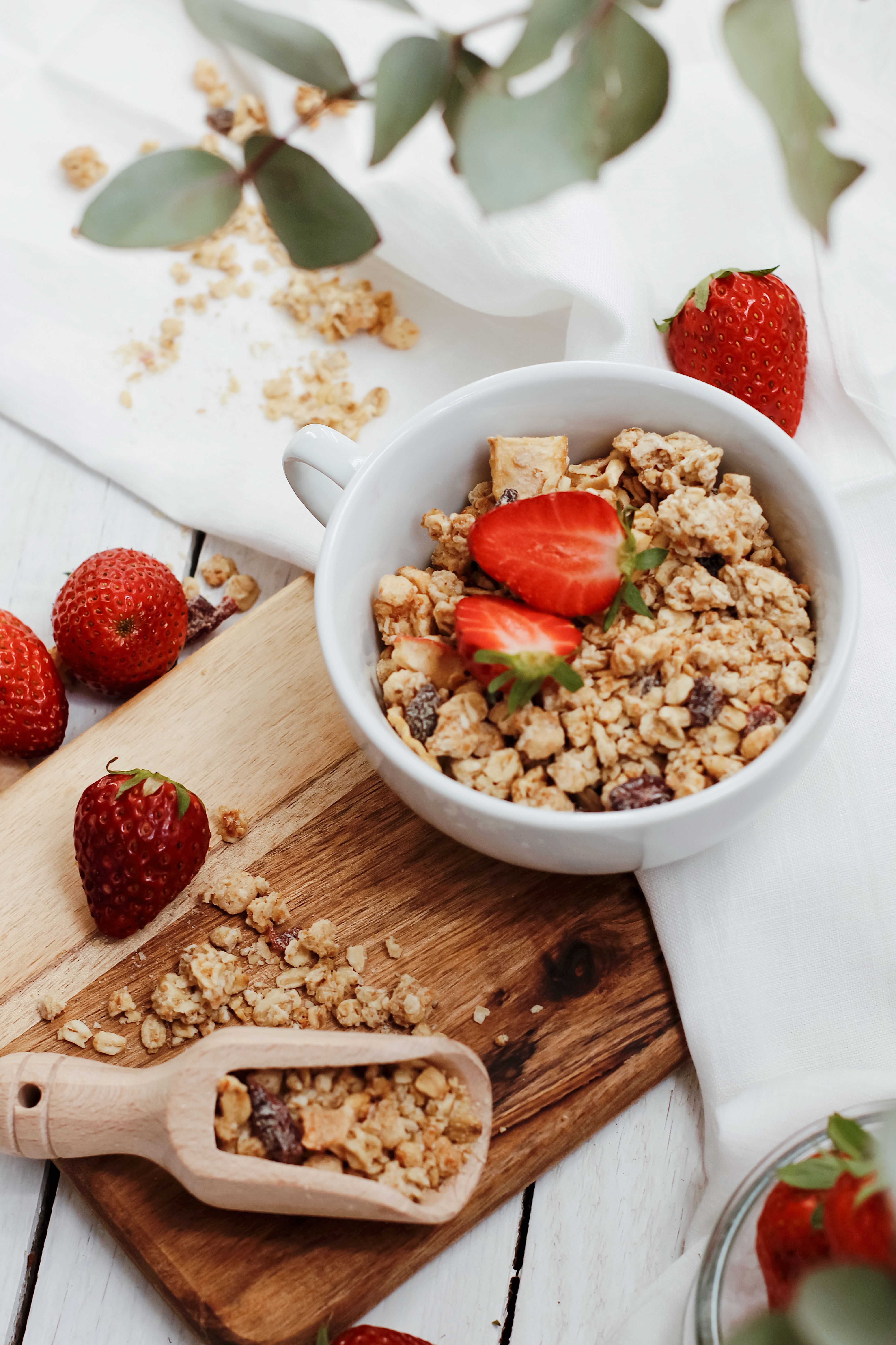 Strawberries in white ceramic bowl with cereal